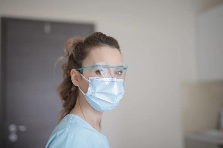 Woman wearing personal protective equipment.